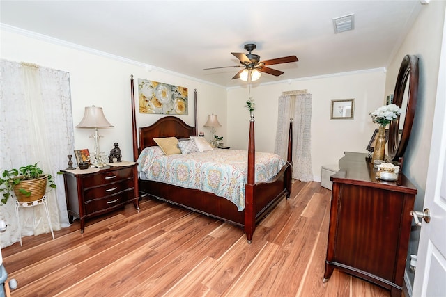 bedroom featuring ceiling fan, light hardwood / wood-style floors, and ornamental molding