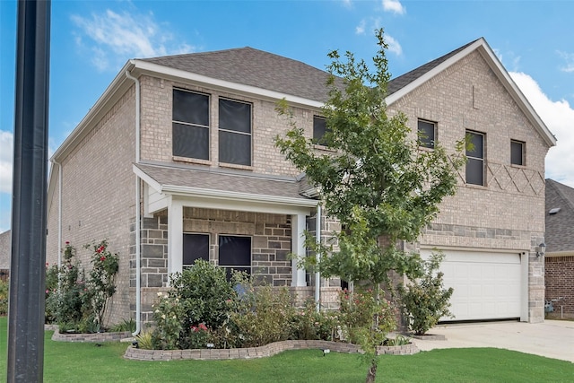 view of front of property featuring a garage and a front lawn