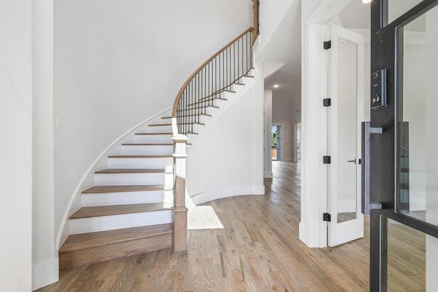 stairs with hardwood / wood-style flooring