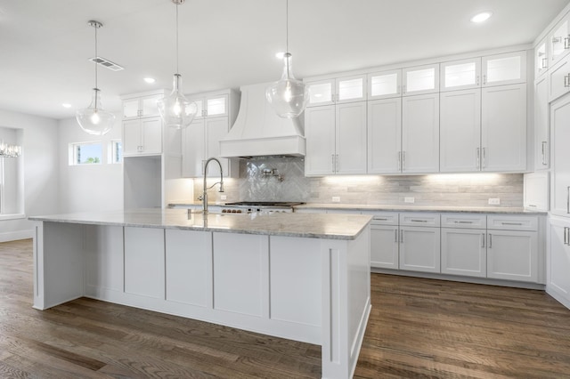 kitchen featuring white cabinets and custom exhaust hood