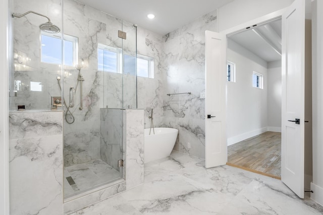 bathroom featuring shower with separate bathtub