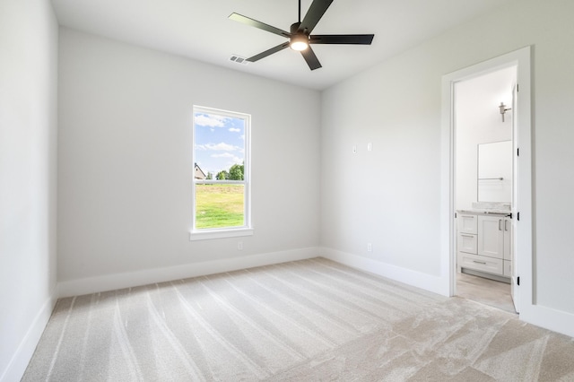 carpeted spare room featuring ceiling fan