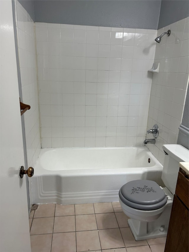 full bathroom with vanity, tile patterned flooring, tiled shower / bath, and toilet