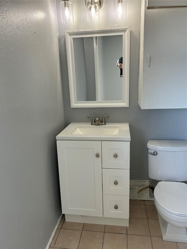 bathroom featuring tile patterned flooring, vanity, and toilet