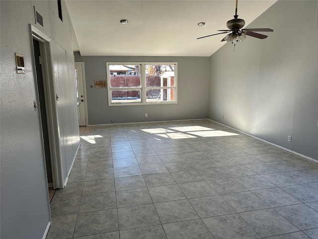 tiled spare room with ceiling fan and lofted ceiling