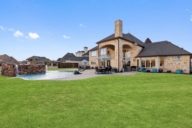 rear view of house with a lawn and a patio area