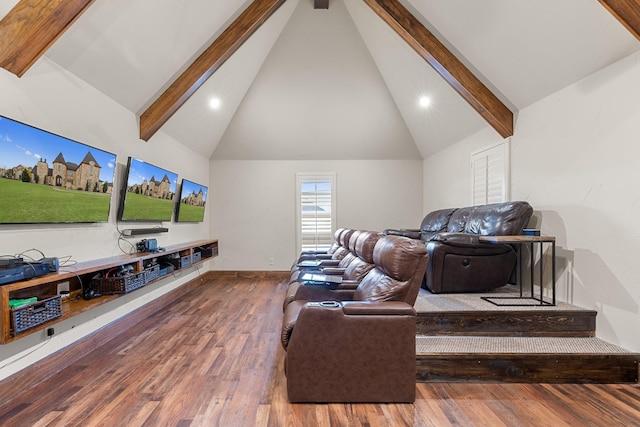 home theater featuring beam ceiling, hardwood / wood-style floors, and high vaulted ceiling