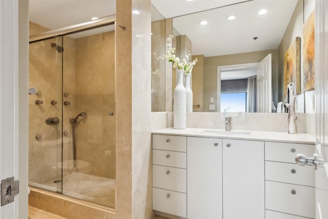 bathroom featuring vanity and an enclosed shower