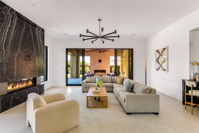 living room featuring a fireplace and a notable chandelier