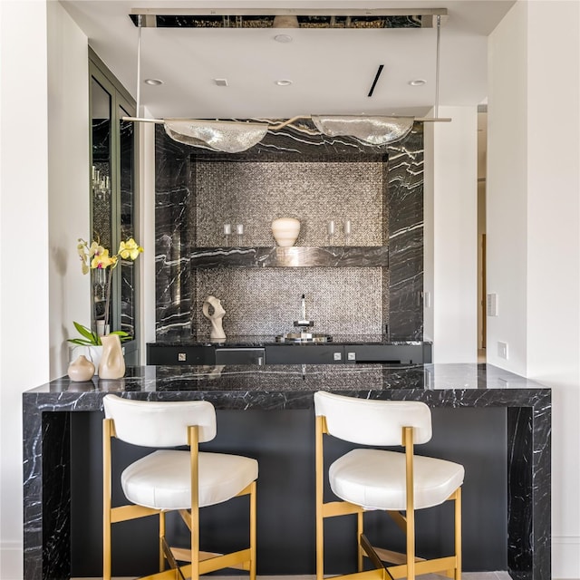 bar featuring decorative backsplash