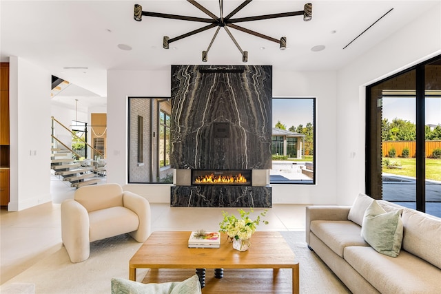 tiled living room featuring a large fireplace