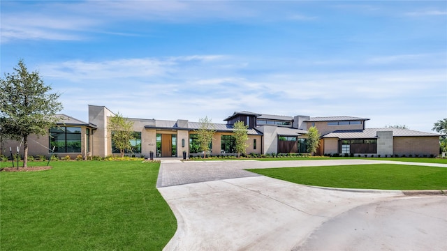 contemporary home with a front lawn