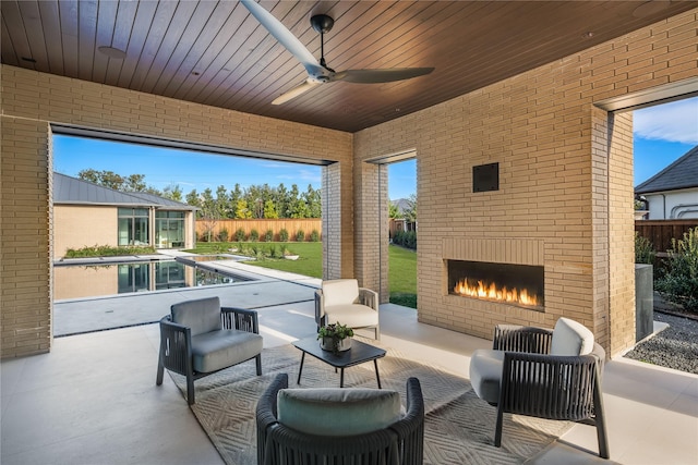 view of patio / terrace with an outdoor living space with a fireplace, a fenced in pool, and ceiling fan