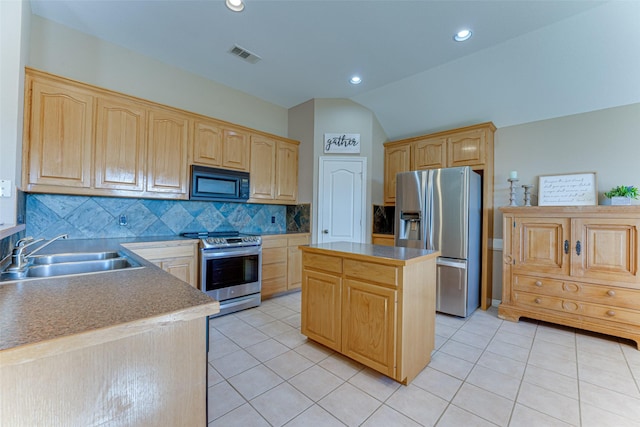 kitchen with sink, stainless steel appliances, backsplash, lofted ceiling, and a kitchen island