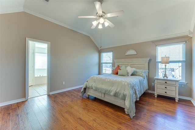 bedroom featuring ceiling fan, dark wood-type flooring, crown molding, connected bathroom, and lofted ceiling