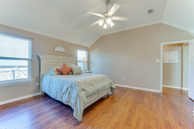 bedroom featuring hardwood / wood-style flooring, crown molding, ceiling fan, and lofted ceiling