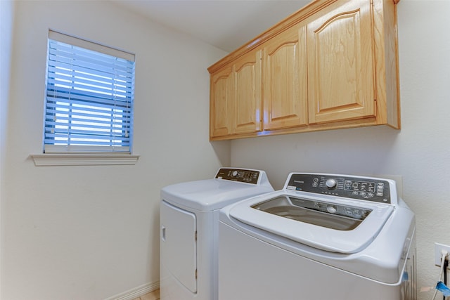 washroom featuring cabinets and washing machine and dryer