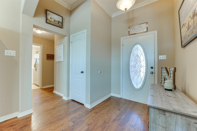 foyer entrance with hardwood / wood-style floors and ornamental molding