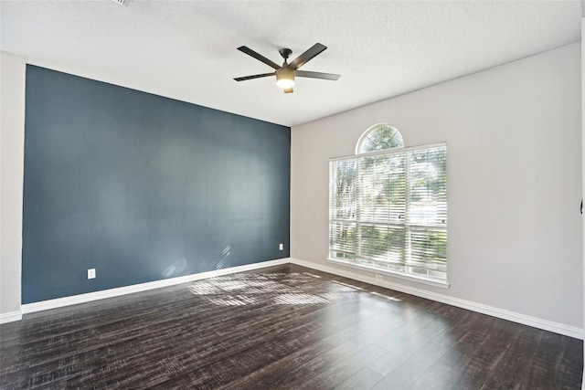 unfurnished room featuring ceiling fan, dark hardwood / wood-style flooring, and a textured ceiling