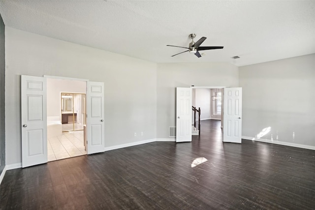 spare room with a textured ceiling, dark hardwood / wood-style flooring, and ceiling fan