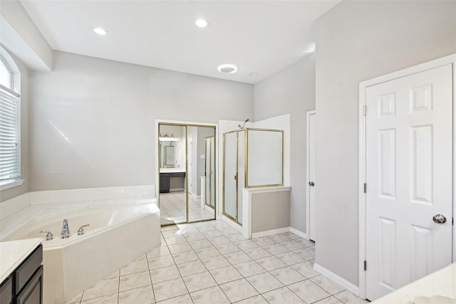 bathroom with tile patterned flooring, vanity, and separate shower and tub