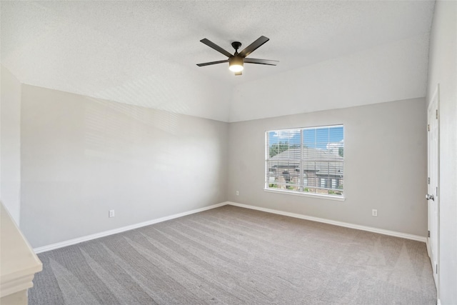 unfurnished room featuring ceiling fan, carpet floors, a textured ceiling, and lofted ceiling