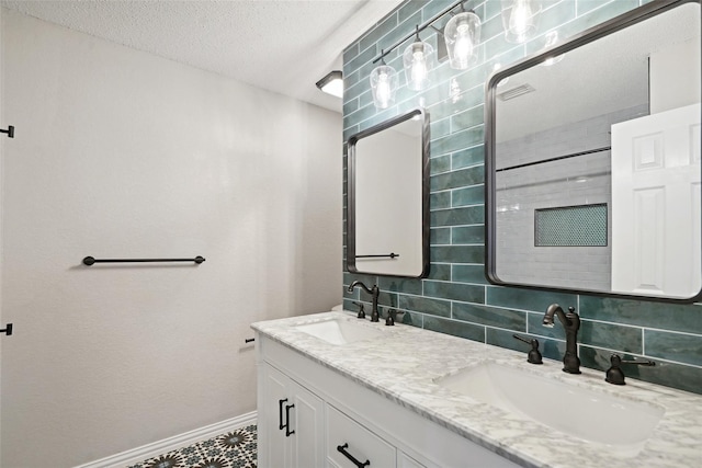 bathroom with backsplash, vanity, and a textured ceiling