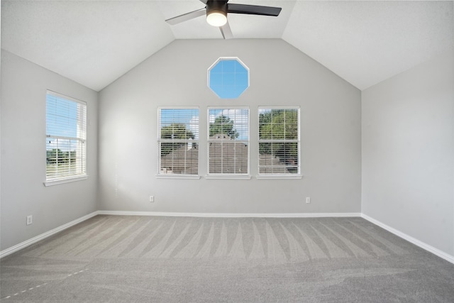 empty room featuring carpet, ceiling fan, and lofted ceiling