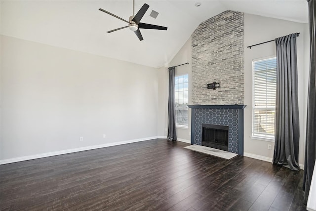 unfurnished living room featuring a fireplace, dark hardwood / wood-style floors, high vaulted ceiling, and ceiling fan