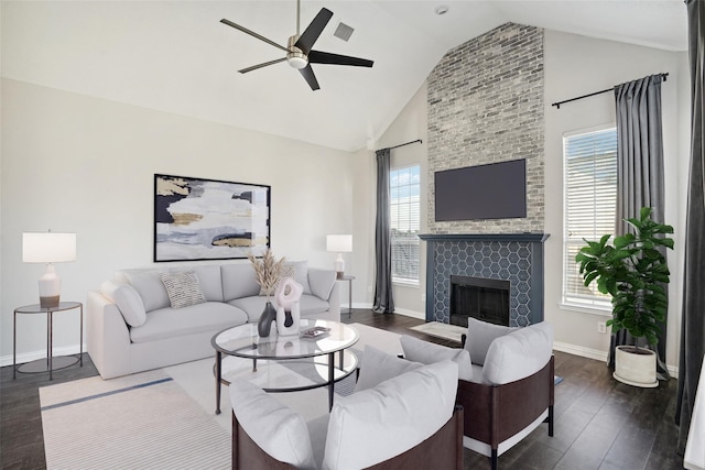 living room with a tile fireplace, ceiling fan, high vaulted ceiling, and dark hardwood / wood-style floors