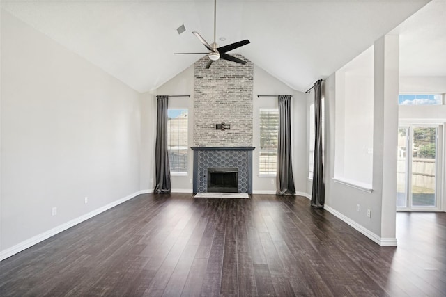 unfurnished living room featuring a fireplace, dark hardwood / wood-style floors, and plenty of natural light