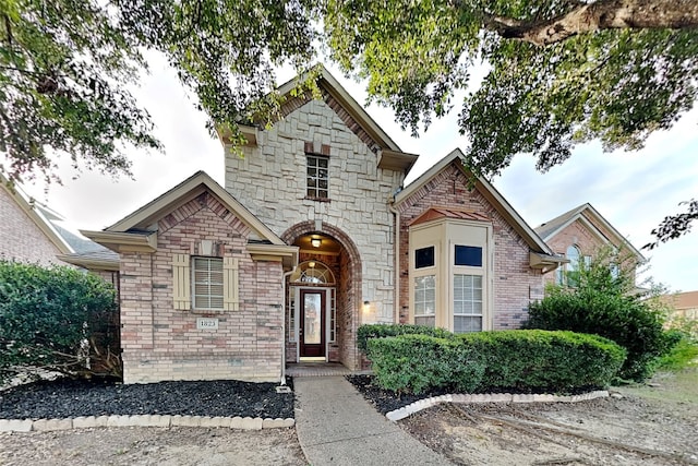 view of front of home featuring stone siding and brick siding