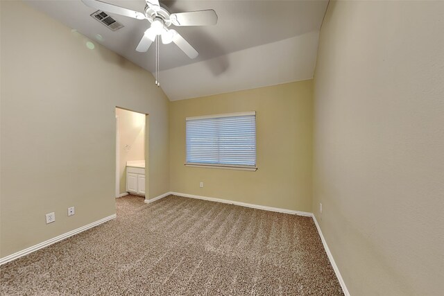 unfurnished bedroom featuring connected bathroom, light colored carpet, vaulted ceiling, and ceiling fan