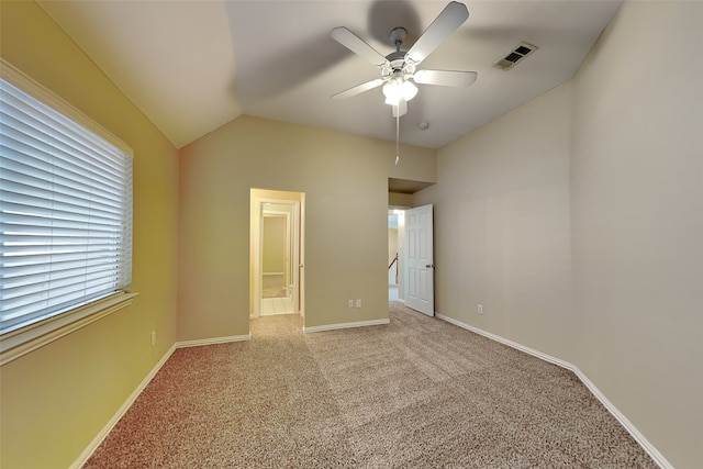 unfurnished bedroom with ceiling fan, light carpet, and vaulted ceiling