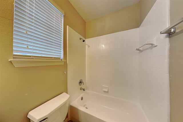 bathroom featuring toilet and shower / tub combination