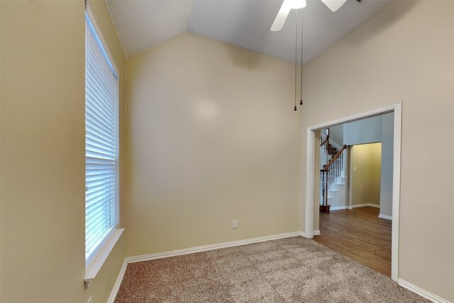 empty room featuring carpet floors, ceiling fan, and lofted ceiling