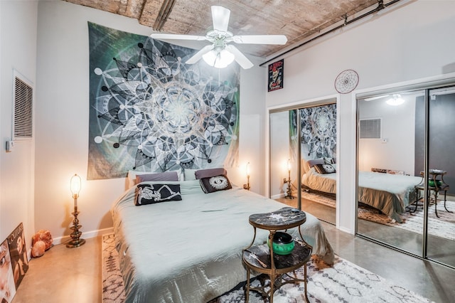 bedroom with ceiling fan and concrete flooring