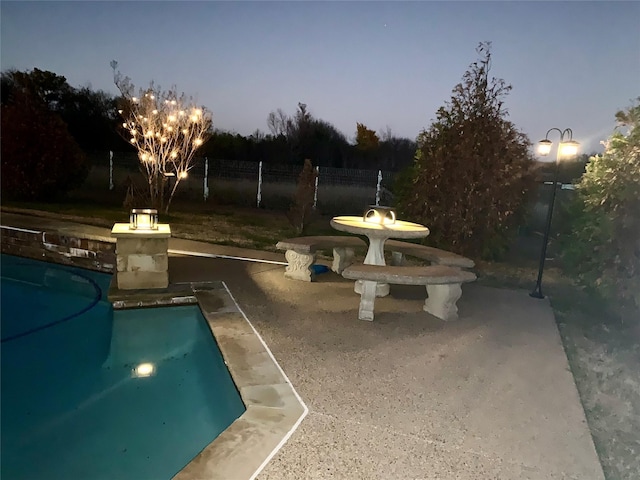 view of pool at dusk