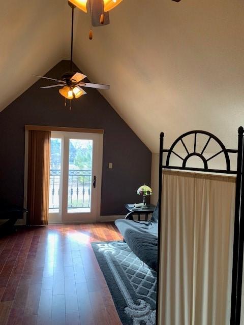 unfurnished bedroom featuring lofted ceiling, ceiling fan, and hardwood / wood-style floors