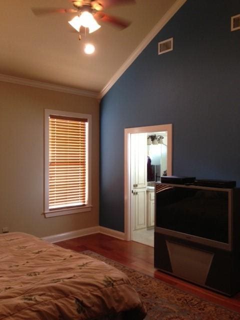 bedroom featuring hardwood / wood-style flooring, ceiling fan, vaulted ceiling, and crown molding