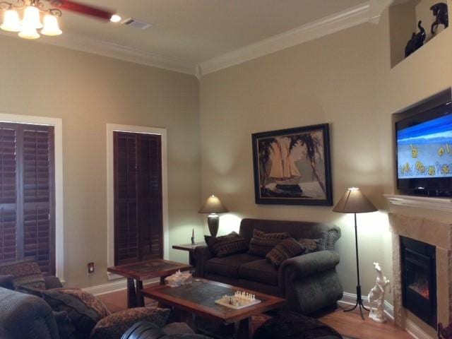 living room with hardwood / wood-style flooring and crown molding