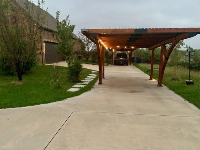 view of patio / terrace with a carport and a garage