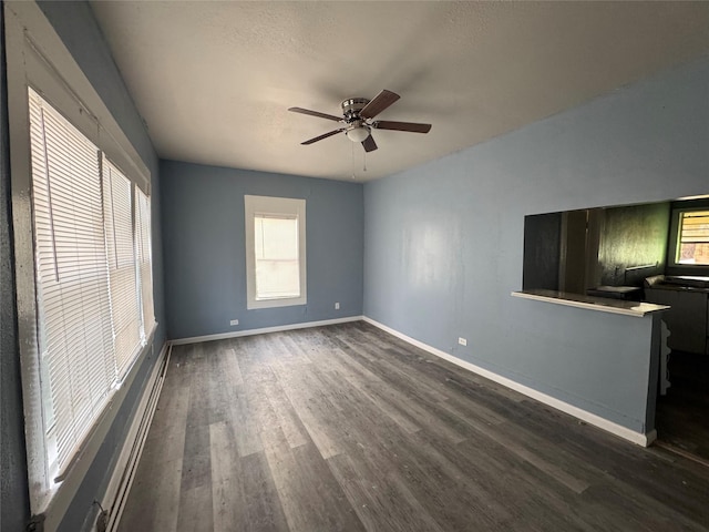 spare room with ceiling fan and dark hardwood / wood-style floors