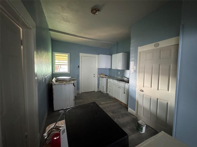 kitchen featuring white cabinets and sink