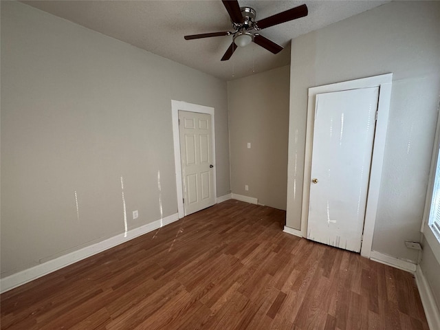 unfurnished bedroom featuring ceiling fan and hardwood / wood-style flooring