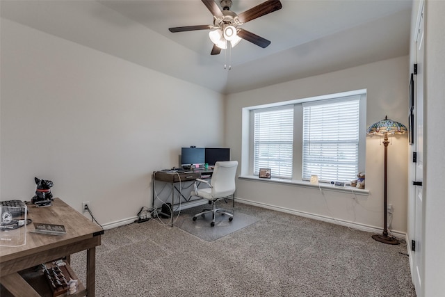 carpeted office space with ceiling fan and vaulted ceiling