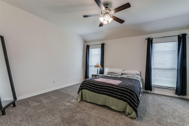 carpeted bedroom with ceiling fan and vaulted ceiling