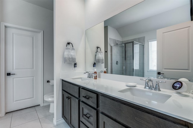 bathroom featuring tile patterned flooring, vanity, toilet, and walk in shower