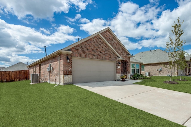 view of front of property featuring a front yard, central AC unit, and a garage