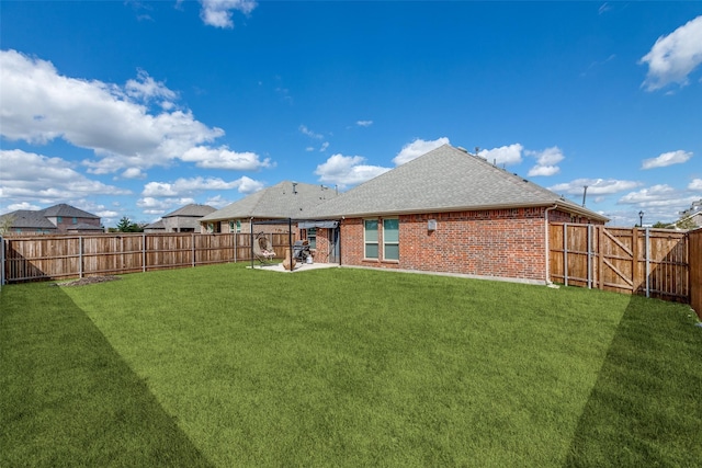 rear view of house featuring a lawn